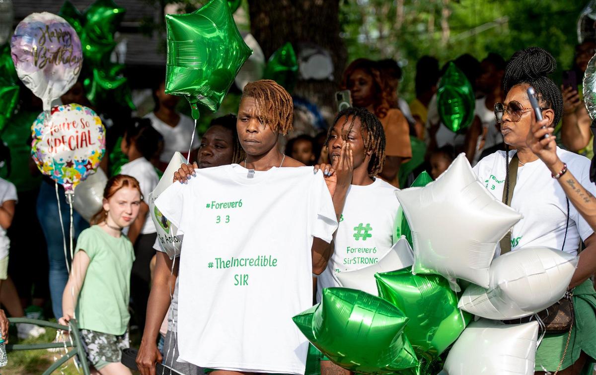 Family of 6-year-old Sir’Antonio Brown stand during a vigil on Wednesday, May 10, 2023, in Kansas City, Kan. Brown was killed May 3 while playing outside his home.