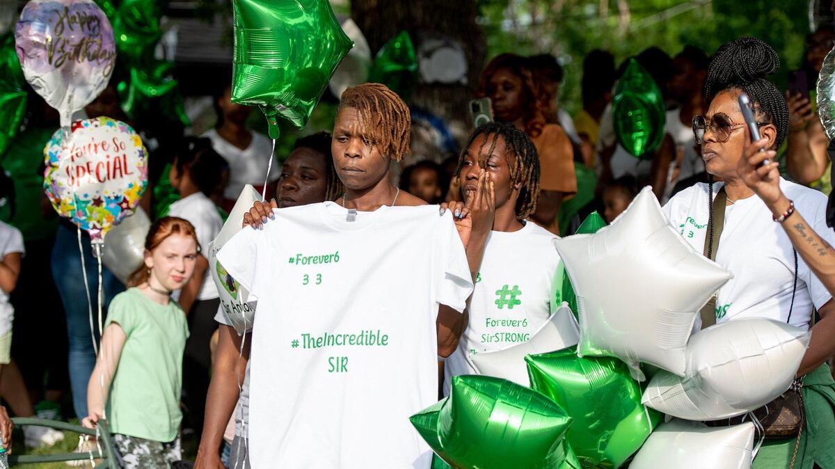 Family of 6-year-old Sir’Antonio Brown stand during a vigil on Wednesday, May 10, 2023, in Kansas City, Kan. Brown was killed May 3 while playing outside his home.