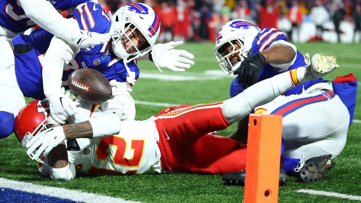 Buffalo Bills safety Jordan Poyer (21) causes a fumble by Kansas City Chiefs wide receiver Mecole Hardman Jr. (12) through the end zone for a touchback during the second half for the 2024 AFC divisional round game at Highmark Stadium.