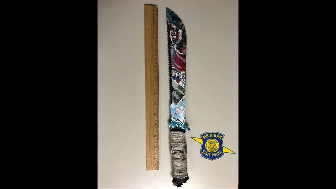 Jordan Cook, 22, was arrested after police say he ran at a Michigan state trooper wielding a machete following a car crash.