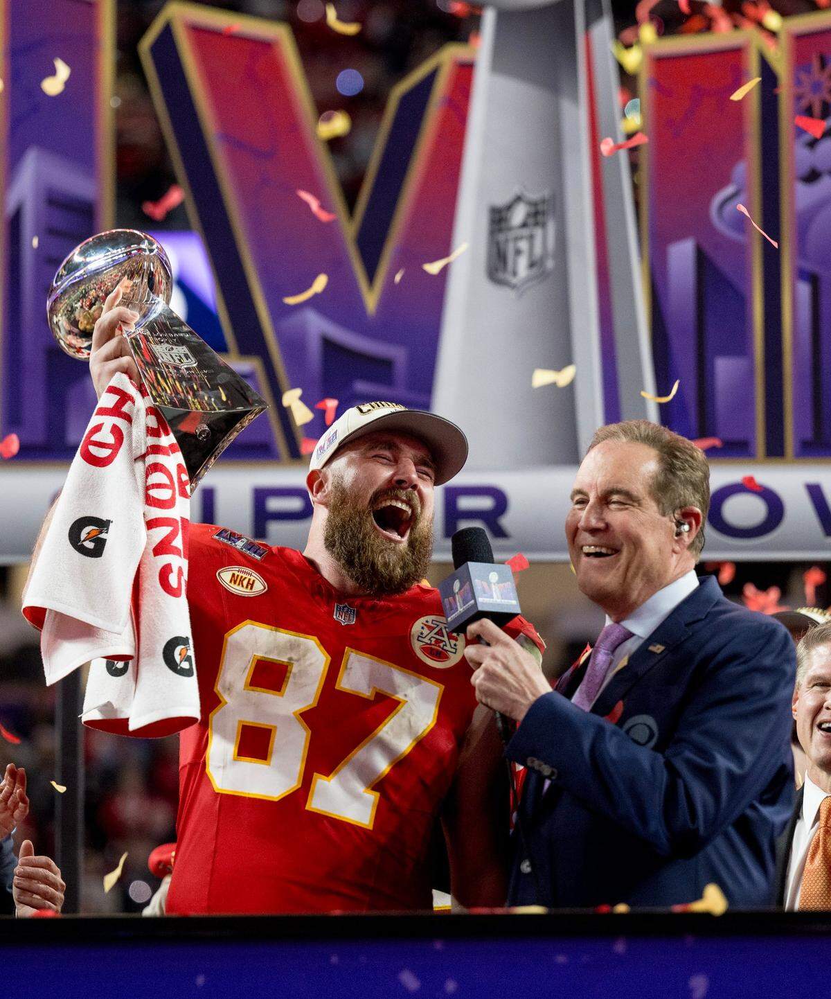 Kansas City Chiefs tight end Travis Kelce (87) hoists the Lombardi Trophy after the Chiefs defeated the San Francisco 49ers in overtime 25-22 in Super Bowl LVIII on Sunday, Feb. 11, 2024, in Las Vegas.
