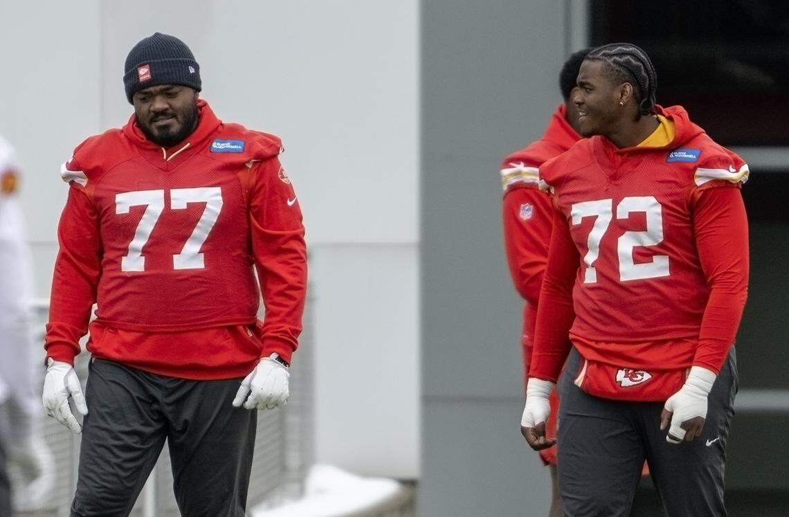 Chiefs tackles Jaylon Moore (77) and Chukwuebuka Godrick (72) stretch during practice on Wednesday, Dec. 3, 2025, in Kansas City.
