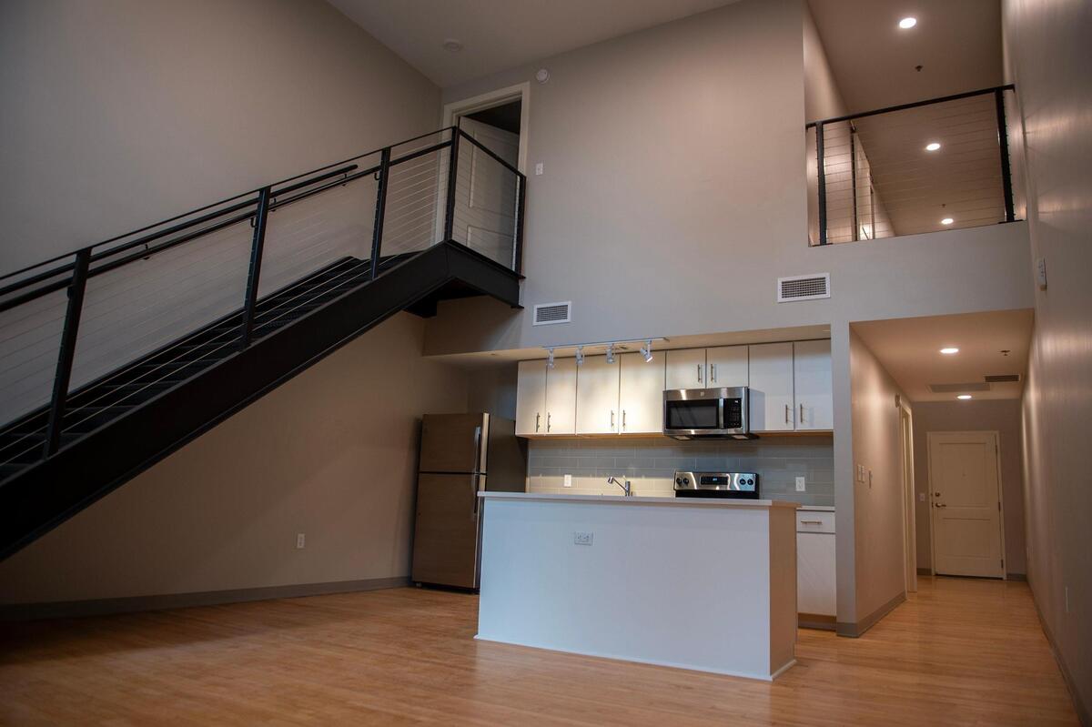Developers converted the building’s basketball court into apartment units. This unique, two-bedroom two-bathroom floor plan features a loft bedroom and bathroom.