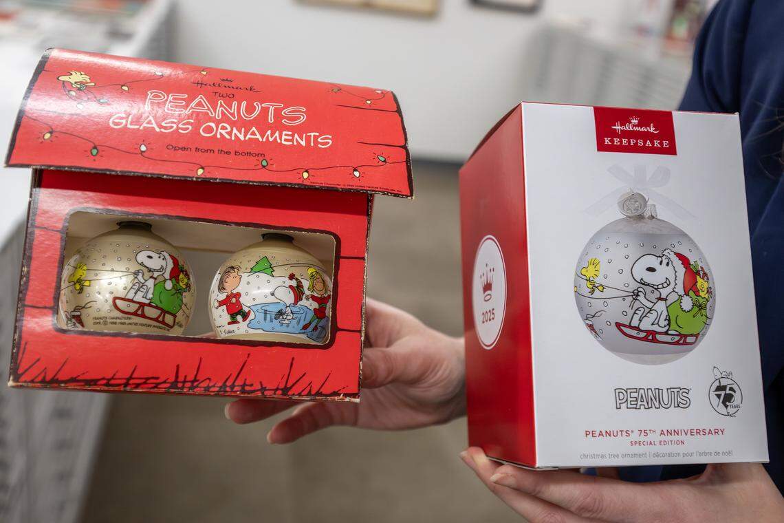 Archivist Samantha Bradbeer-Stephens showcases the original Peanuts ornaments and the 75th anniversary edition in the Hallmark archives at the Hallmark headquarters on Tuesday, Aug. 5, 2025, in Kansas City.