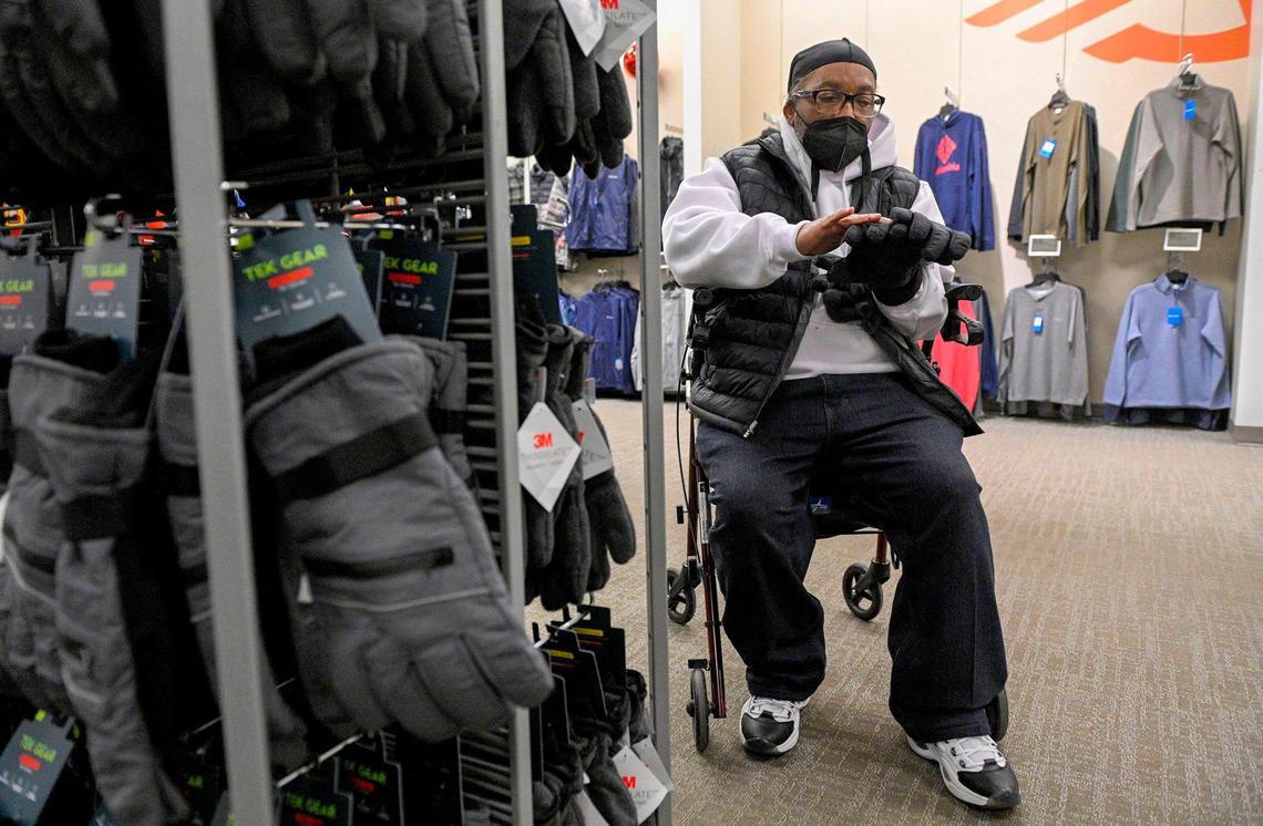 Kevin Strickland tries on winter gloves Tuesday, Dec. 21, 2021, while out shopping. Strickland, 62, exonerated in a 1978 triple murder that local prosecutors said he did not commit, has been free for one month.