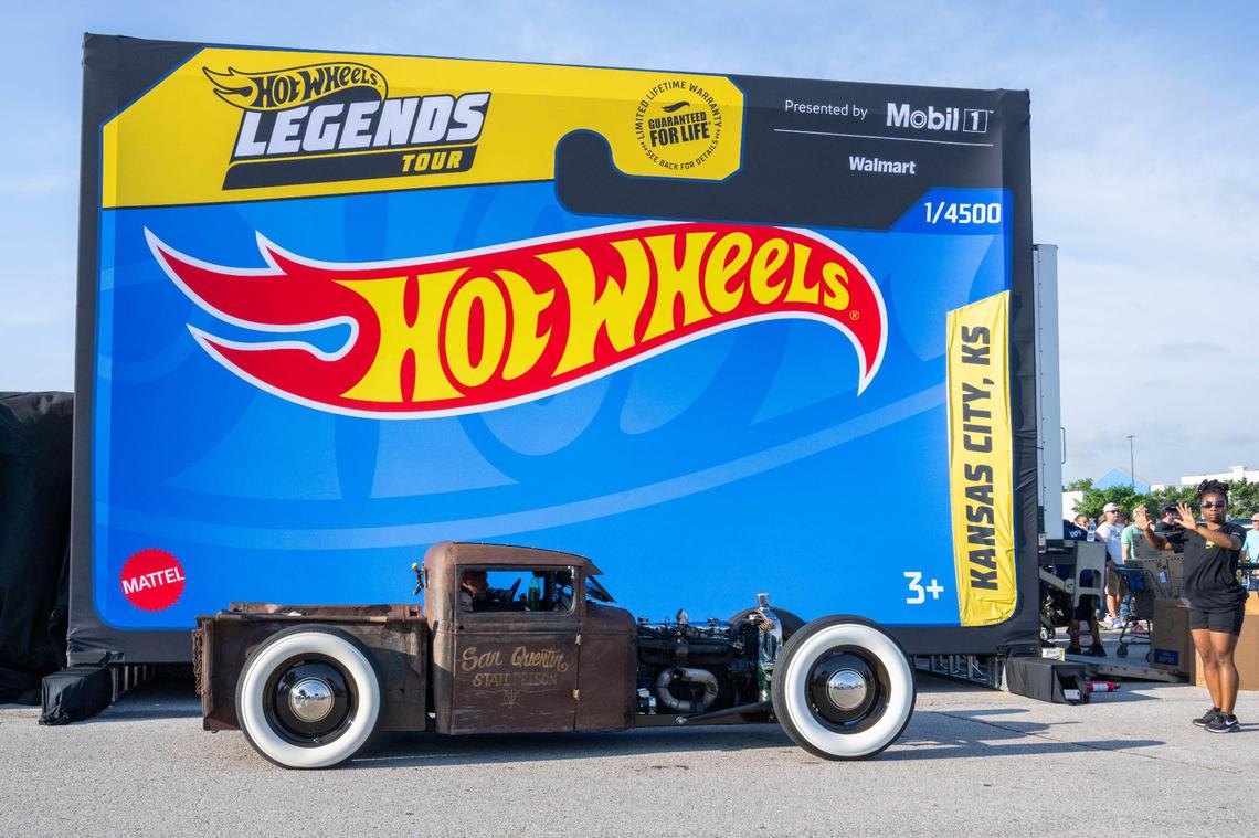 A classic hot rod pulls up in front of the Hot Wheels backdrop to take a photo at the Kansas City stop of the Hot Wheels Legends Tour on Saturday, July 12, 2005 in Gardner, Kansas. Nearly 100 cars parked side by side and were judged on whether or not they would be selected as the newest Hot Wheels diecast car.