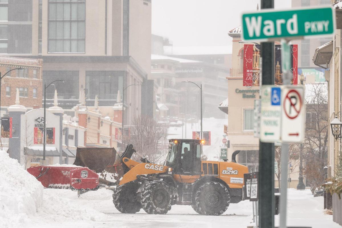 A snow plow pushes snow around on the Country Club Plaza in Kansas City on Sunday, Jan. 5, 2025.