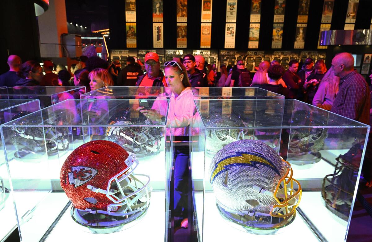 Football fans viewed ‘glammed out” football helmets as they waited to view Super Bowl Championship rings at the Super Bowl Experience, on Thursday, Feb. 8, 2024, in Las Vegas, Nevada.