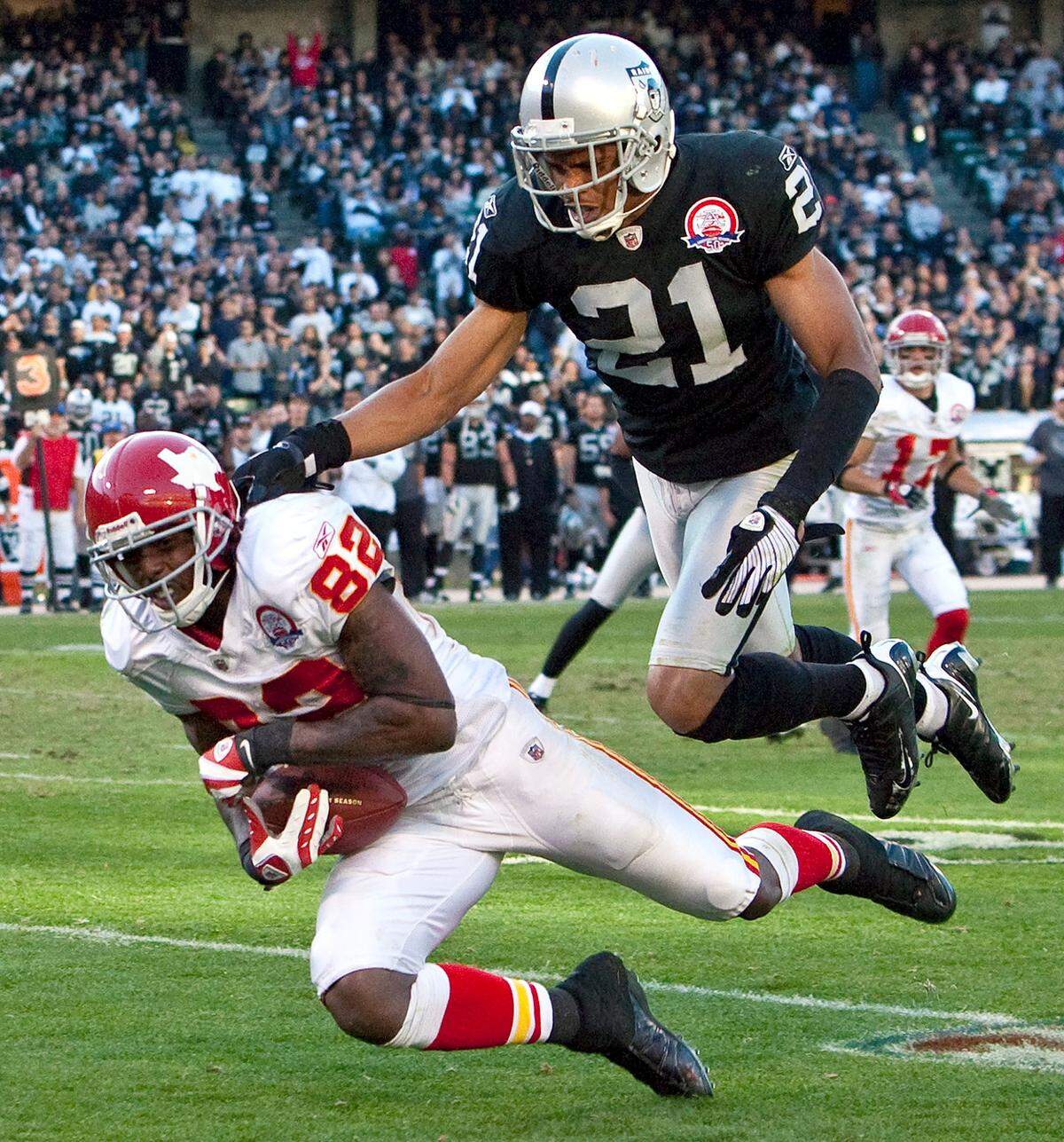 Kansas City Chiefs wide receiver Dwayne Bowe (82) dropped a 19-yard pass, but Oakland Raiders cornerback Nnamdi Asomugha (21) interfered with the reception giving the Chiefs a 19-yard gain with 9:51 remaining in the fourth quarter during Sunday’s November 15, 2009 football game between the Kansas City Chiefs and Oakland Raiders at Oakland-Alameda County Coliseum in Oakland, CA. John Sleezer/The Kansas City Star