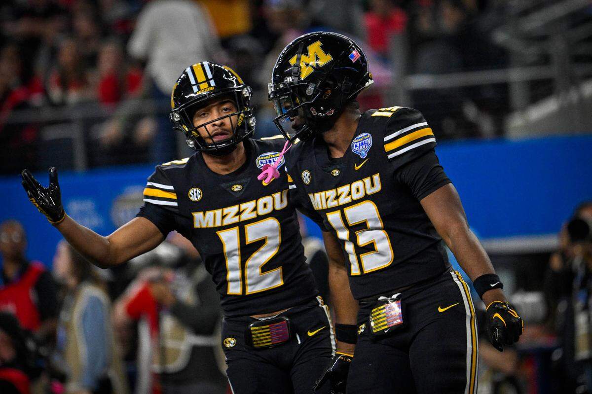 Missouri Tigers defensive back Dreyden Norwood, left, and defensive back Daylan Carnell celebrate a stop against the Ohio State Buckeyes during Friday night’s Cotton Bowl at AT&T Stadium in Arlington, Texas.