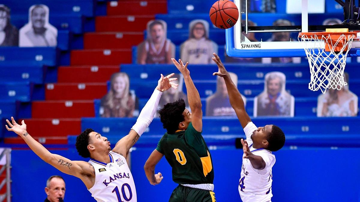 KU teammates Jalen Wilson,left,a dn Bryce Thompson, right, defend NDSU’s Dezmond McKinney on a shot during the first half of the Jayhawks game Saturday afternoon against North Dakota State University at Allen Fieldhouse.