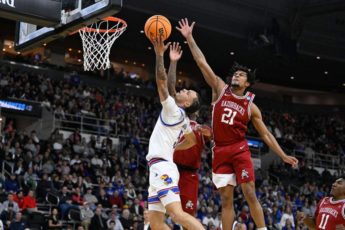 Kansas Jayhawks guard Zeke Mayo, left, puts up a shot against the defense of Arkansas Razorbacks guard D.J. Wagner during a first-round NCAA Tournament men’s basketball game at Amica Mutual Pavilion in Providence, Rhode Island, on Thursday, March 20, 2025.