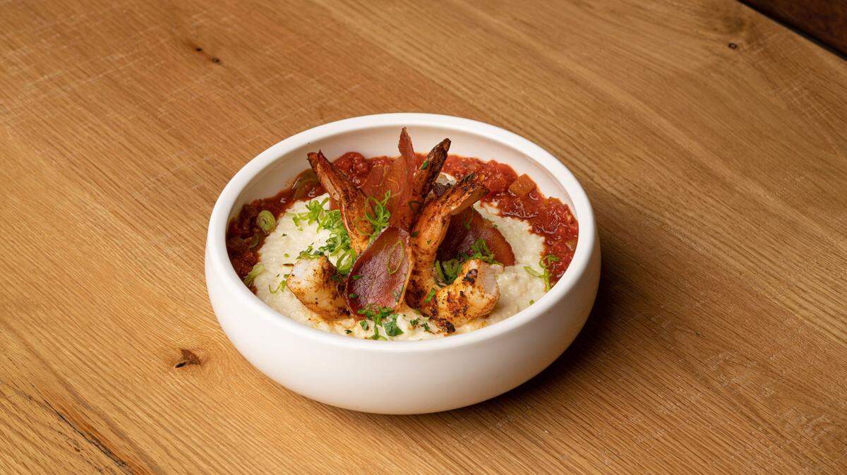 Minglewood’s Shrimp and Grits has Cajun seasoned and grilled shrimp, white cheddar grits, country ham and red gravy.