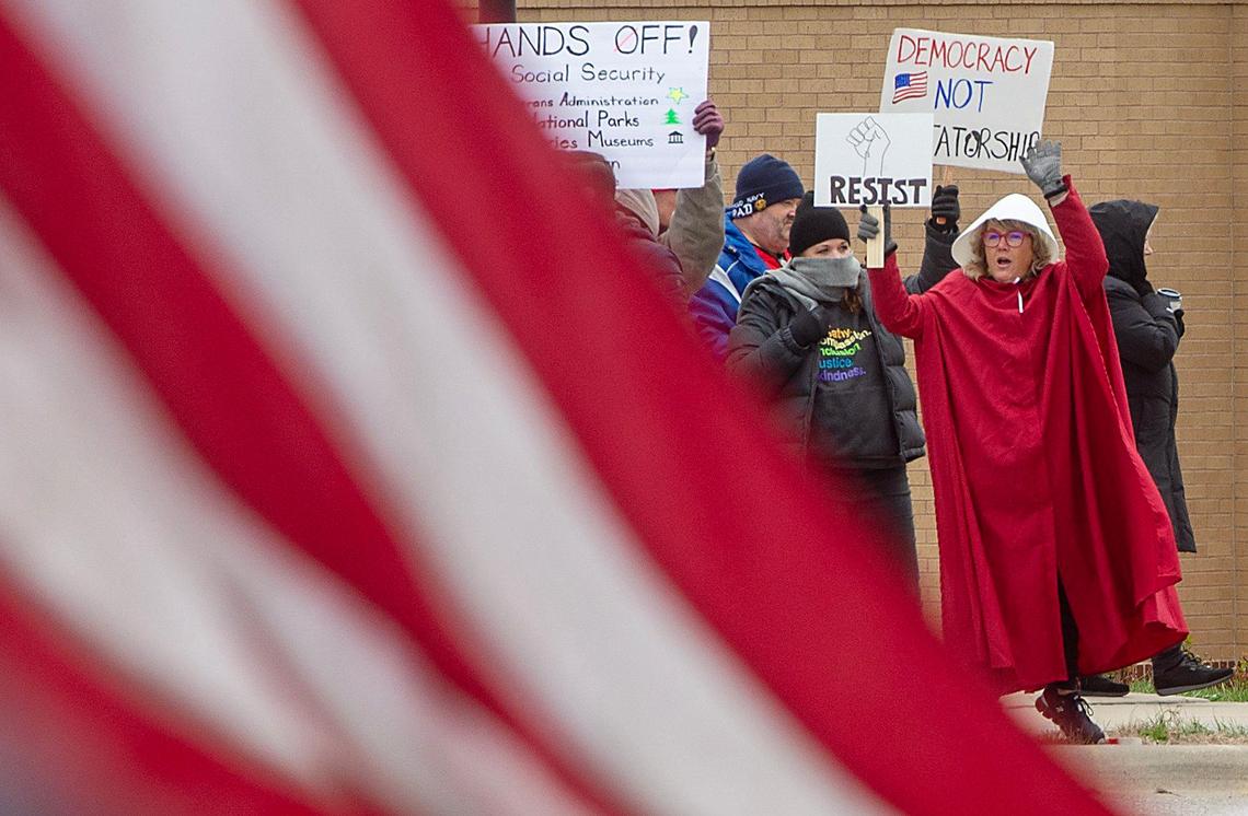 Pro-democracy demonstrators gathered near West 87th Street and Maurer Road in Lenexa on Saturday, April 5, 2025, to protest the policies of the Trump administration. The protest was part of an organized nationwide effort called “Hands off!”.