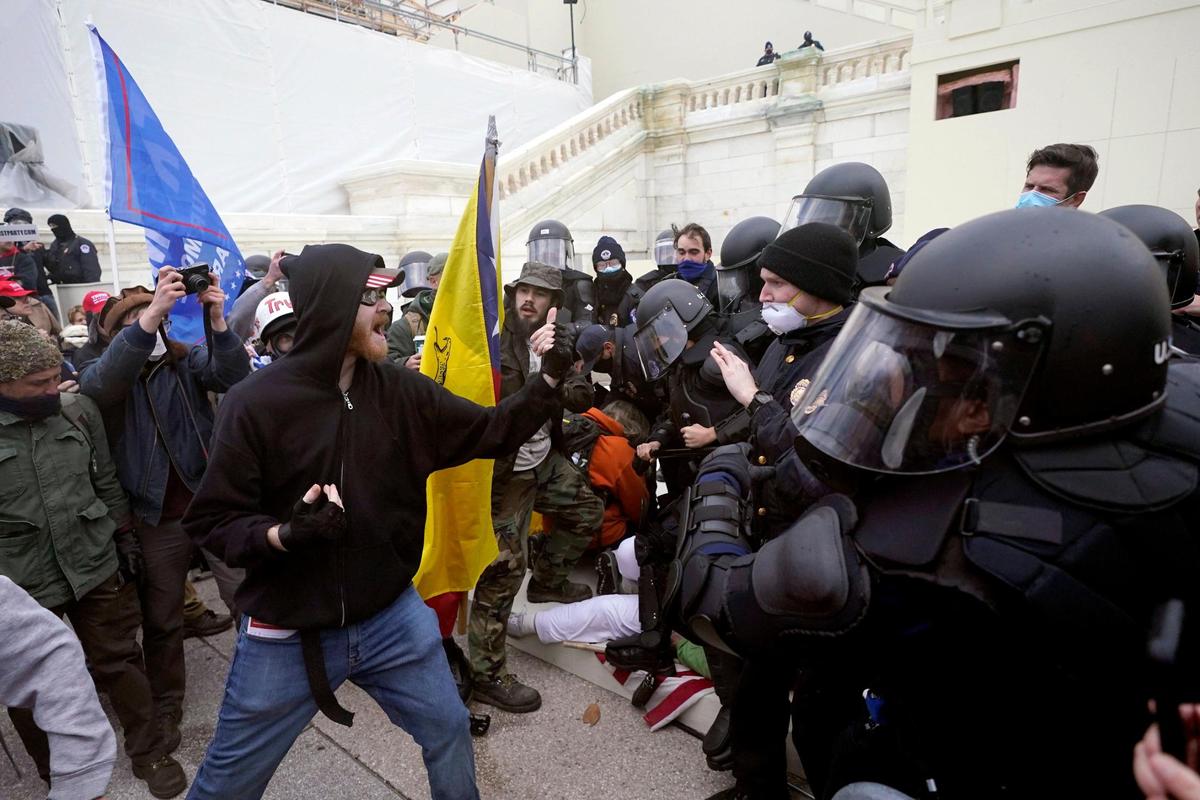 Trump supporters try to break through a police barrier, Wednesday, Jan. 6, 2021, at the Capitol in Washington. As Congress prepares to affirm President-elect Joe Biden’s victory, thousands of people have gathered to show their support for President Donald Trump and his claims of election fraud. (AP Photo/Julio Cortez)