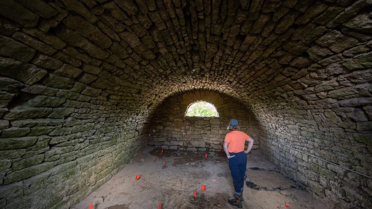 Archaeologist Ann Raab inside the historic Halfway House Cellar on Tuesday, June 23, 2026, in Weston. Raab instructs a class excavating a small area where the former Halfway House tavern and inn previously stood. The cellar is believed to have held enslaved people.