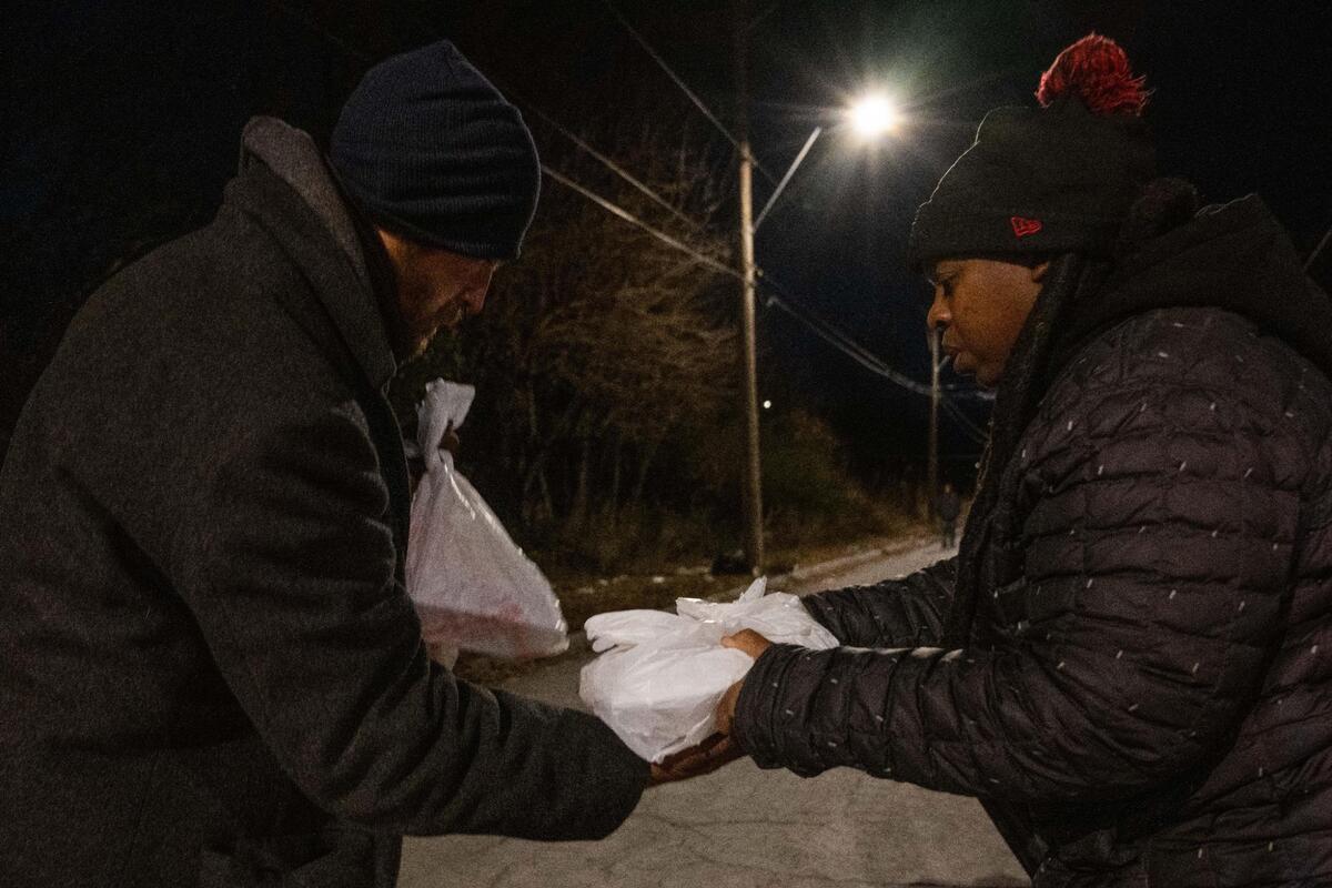 Adrienne Gilchrist delivers a hot meal to Cole, an unhoused man in Kansas City on Giving Tuesday, Giving Tuesday is a global event that takes place each year on the first Tuesday after Thanksgiving and is made up of initiatives to help communities in need.