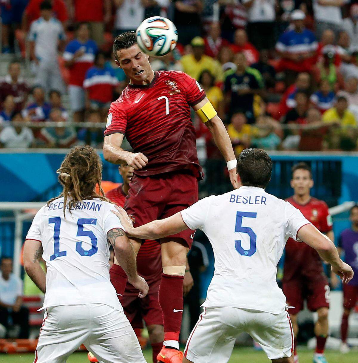 Portugal forward Cristiano Ronaldo (7) goes up for a header between United States midfielder Kyle Beckerman (15) and defender Matt Besler (5) during the second half of a 2-2 draw at the 2014 World Cup at Arena Amazonia in Brazil.