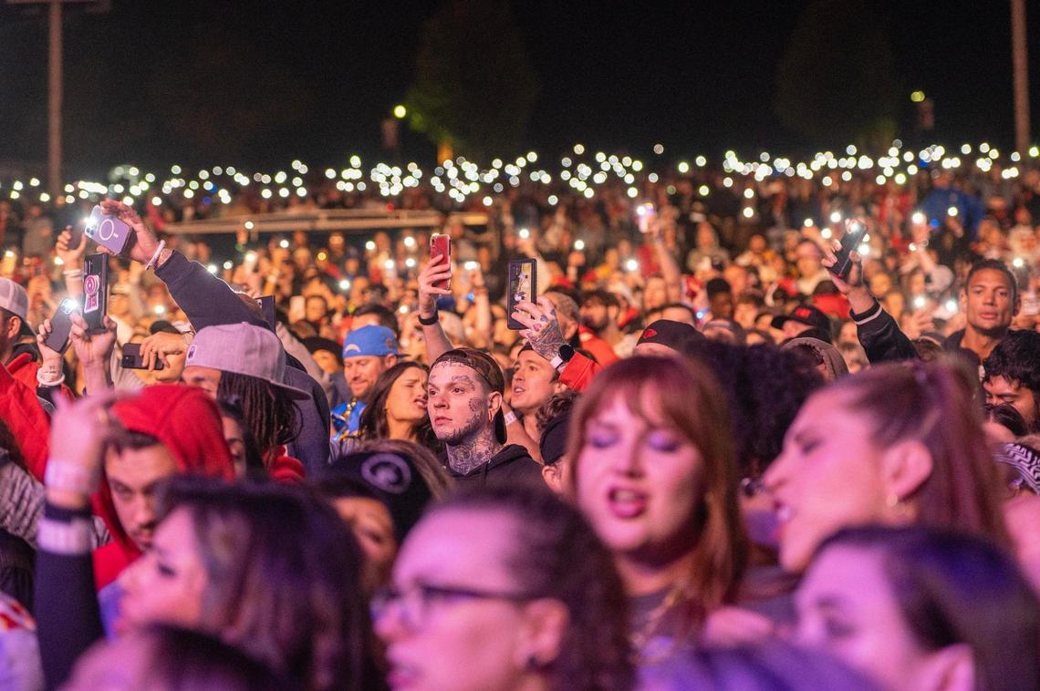 Fans hold up their cellphone lights while Machine Gun Kelly performs at Kelce Jam at Azura Amphitheatre on Friday, April 28, 2023, in Bonner Springs.