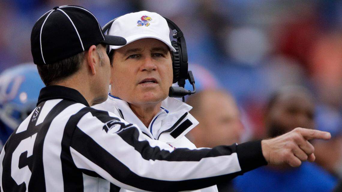 In this Oct. 5, 2019, file photo, Kansas head coach Les Miles, right, talks to an official during the first half of an NCAA college football game against Oklahoma in Lawrence, Kan.