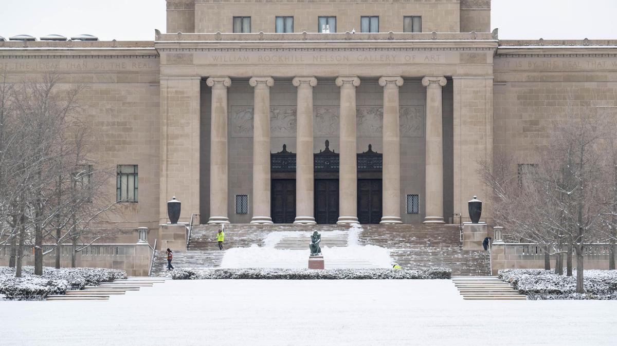 Workers outside The Nelson-Atkins Art Museum clear snow from the steps of the museum in Kansas City on Wednesday, Feb. 12, 2025.