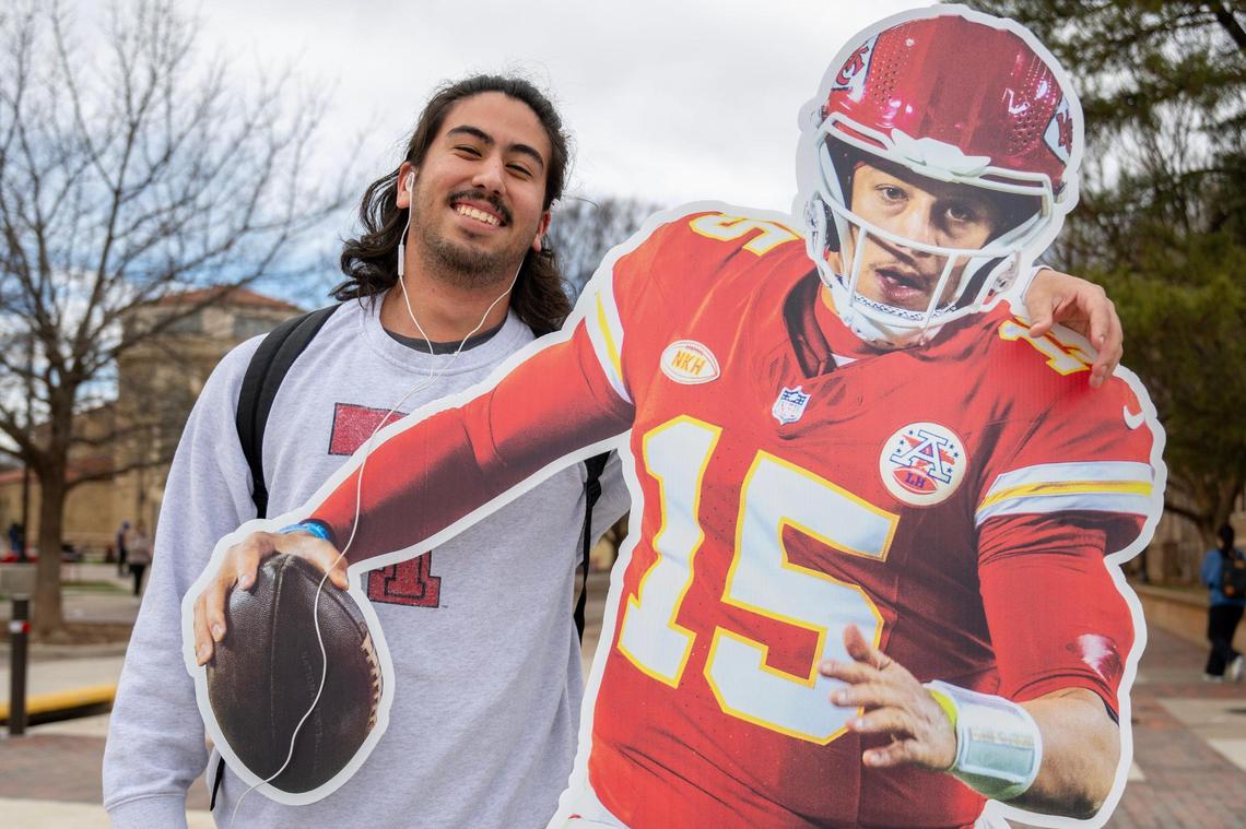 Malachi Mendoza, a Texas Tech University student, poses for a photo next to a life-size cutout featuring Kansas City Chiefs quarterback Patrick Mahomes on Tuesday, Feb. 6, 2024, at Texas Tech University in Lubbock, Texas.