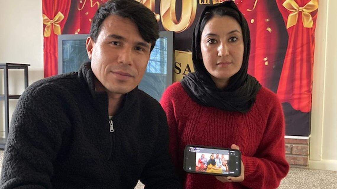 Samia Tahiri and her husband, Qasim Rahimi, refugees from Afghanistan to Kansas City, hold up a photo of Tahiri’s family who fled the Taliban-ruled country to Pakistan. An executive order suspending the arrivals of new refugees to The U.S., places the family’s future in limbo. “Nothing is clear right now,” Tahiri said.