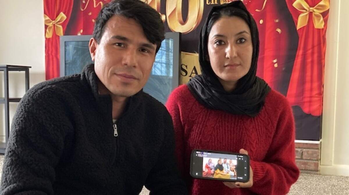 Samia Tahiri and her husband, Qasim Rahimi, refugees from Afghanistan to Kansas City, hold up a photo of Tahiri’s family who fled the Taliban-ruled country to Pakistan. An executive order suspending the arrivals of new refugees to The U.S., places the family’s future in limbo. “Nothing is clear right now,” Tahiri said.