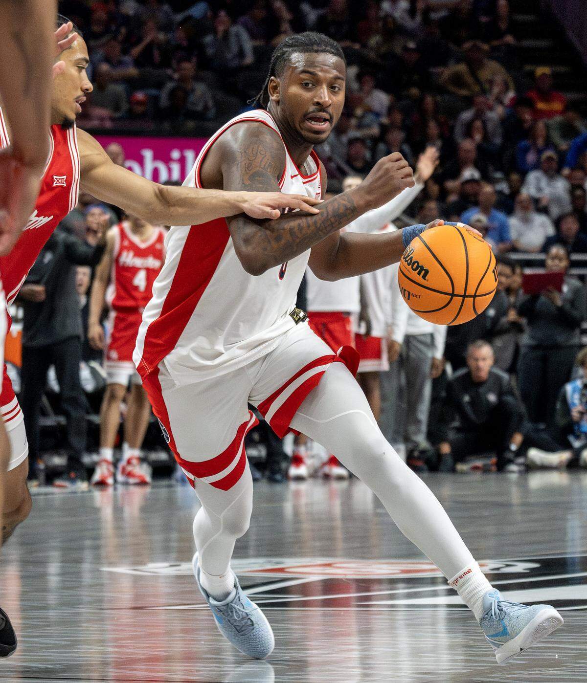 Houston Cougars guard Kordel Jefferson (0) shields the ball from Houston Cougars center Chris Cenac Jr. (5) during the second half of the Big 12 Men's Basketball Tournament Championship game at T-Mobile Center on Saturday, March 14, 2026, in Kansas City.