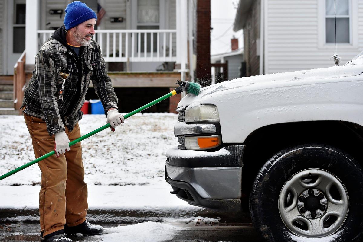 Getting ready to work helping a friend, Martin Sharkey of North Kansas City used a broom to remove snow from his truck after snow covered the Kansas City area Jan. 29, 2020. A winter advisory remained in effect until noon.
