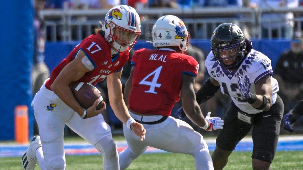 Kansas Jayhawks quarterback Jason Bean (No. 17) takes off with the ball during Saturday’s game against the TCU Horned Frogs at Booth Memorial Stadium Lawrence, Kan.