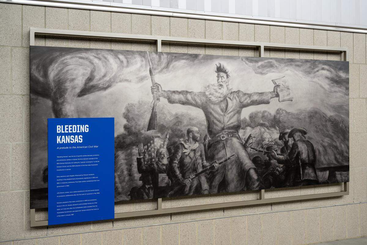 A display entitled "Bleeding Kansas" features a mural of John Brown, a radical abolitionist, at the renovated David Booth Kansas Memorial Stadium on Tuesday, Aug. 19, 2025, at the University of Kansas in Lawrence.  