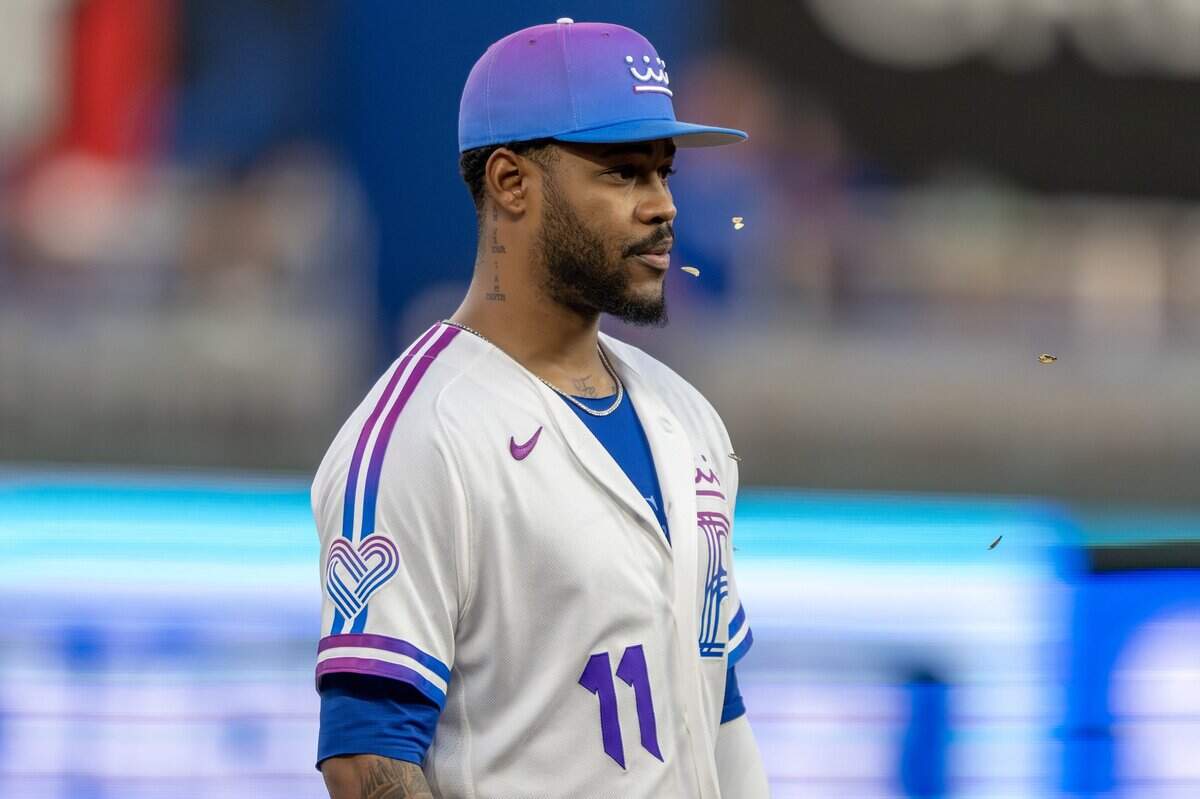 Wearing the Kansas City Royals' new "Forever Fountains" City Connect uniform, third baseman Maikel Garcia (11) spits sunflower seeds while watching a play in the third inning against the Houston Astros on Friday, June 12, 2026, at Kauffman Stadium in Kansas City.