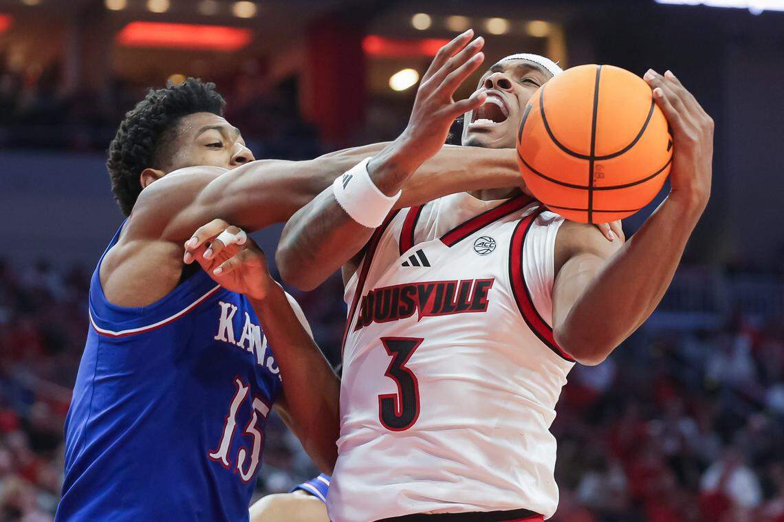 LOUISVILLE, KENTUCKY - OCTOBER 24: Bryson Tiller #15 of the Kansas Jayhawks defends against the shot from Ryan Conwell #3 of the Louisville Cardinals during the first half of the NCAA exhibition game Louisville Cardinals vs Kansas Jayhawks at KFC YUM! Center on October 24, 2025 in Louisville, Kentucky. (Photo by Michael Hickey/Getty Images)