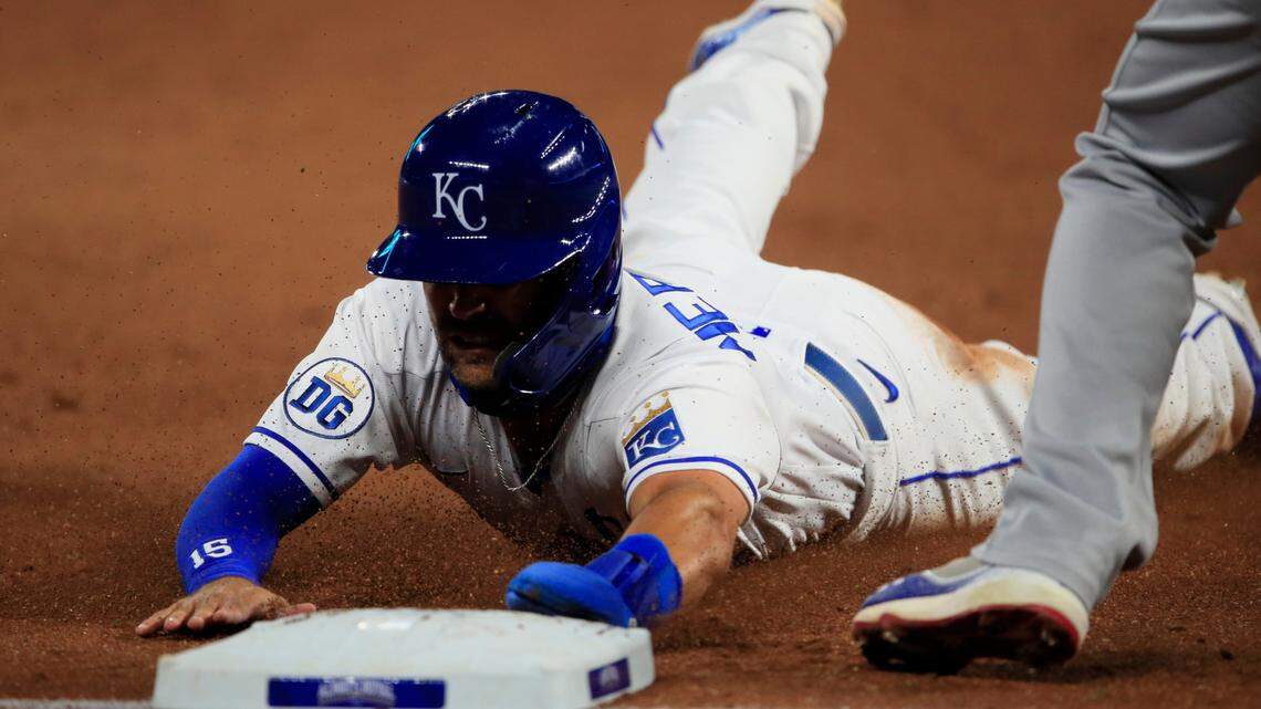 Kansas City Royals Whit Merrifield slides into third base during the sixth inning of a baseball game against the Chicago Cubs at Kauffman Stadium in Kansas City, Mo., Wednesday, Aug. 5, 2020. Merrifield advanced to third on a foul out by teammate Jorge Soler. (AP Photo/Orlin Wagner)