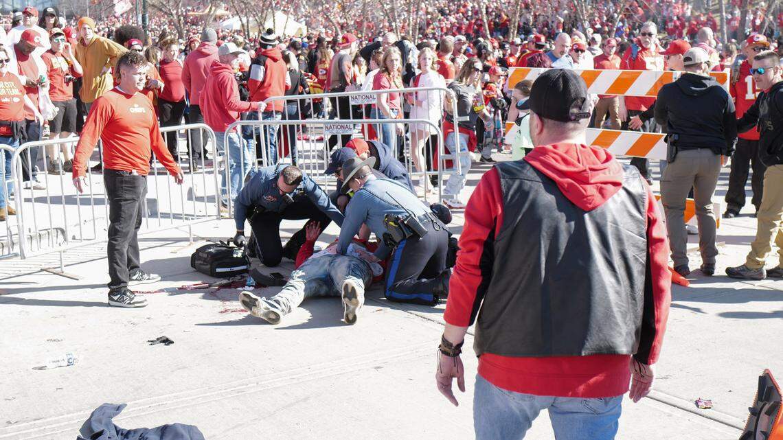 Law enforcement officers and emergency personnel aid a person who had been shot Wednesday near Union Station moments after the Kansas City Chiefs Super Bowl victory rally had ended. Curtis Hoback, who takes photos as a hobby, made this image and several others of the chaos after more than 20 people were shot and one killed there.