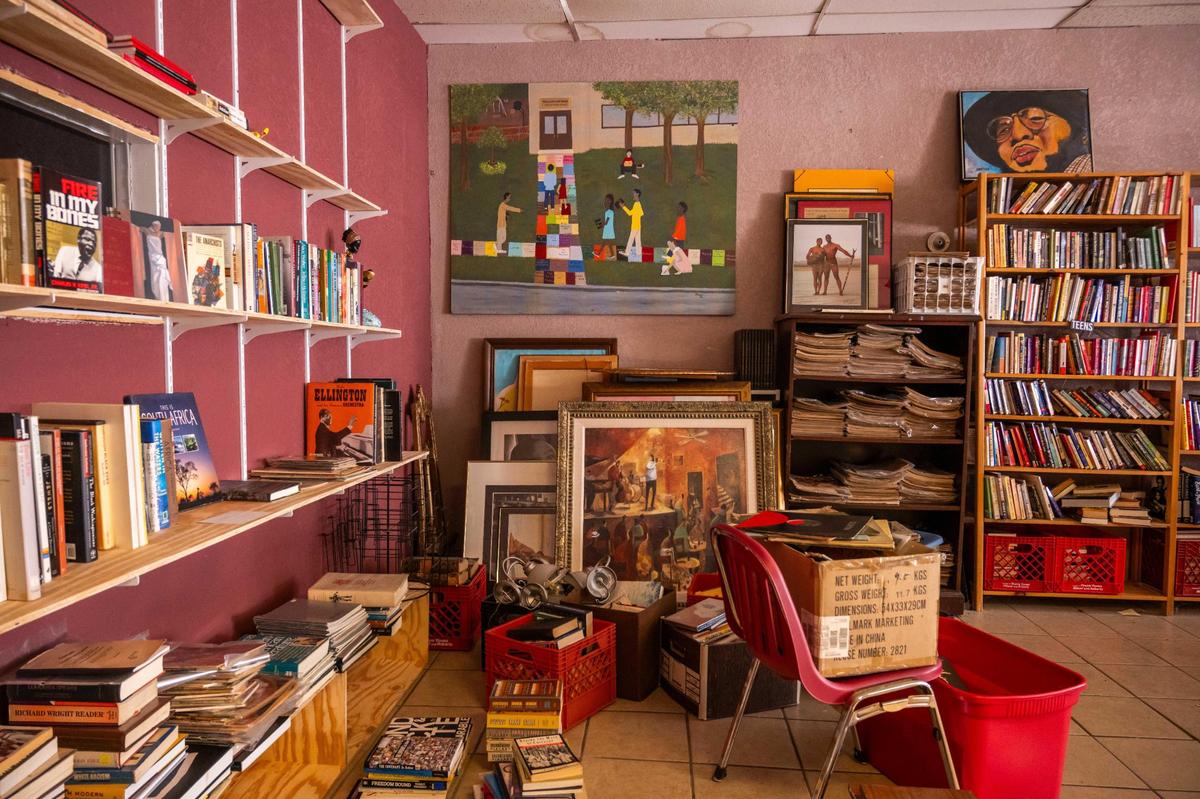 Stacks of artwork and books sit in a corner inside Willa’s Books & Vinyl on Thursday, July 10, 2025. Willa’s will close on Saturday as Robinson goes into retirement. Local news outlet, The Kansas City Defender, will assume responsibility for the books and items that remain and plan to convert the space into a public archive and community space.