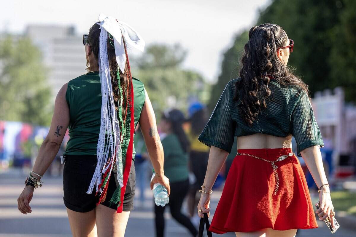 Mexico fans dressed in red, white and green leave the FIFA Fan Festival on Thursday, June 11, 2026, in Kansas City.