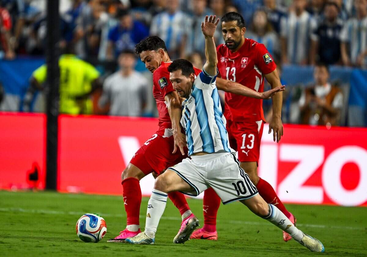 Argentina forward Lionel Messi (10) makes a play for the ball surrounded by Swiss defenders in the Argentina vs. Switzerland 2026 World Cup Quarterfinal football match at Kansas City (Arrowhead) Stadium in Kansas City on Saturday, July 11, 2026.