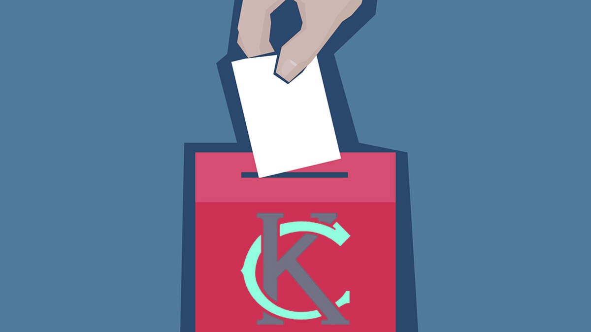 Hand puts ballot in the Kansas City ballot box