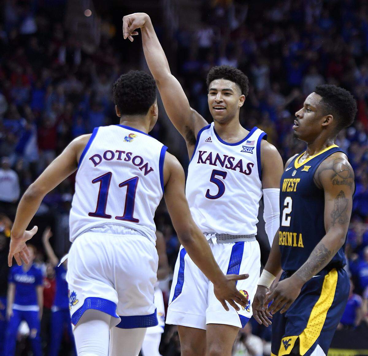 After hitting another three-point shot, KU’s Quentin Grimes (5) and teammate Devon Dotson head back down court past West Virginia’s Brandon Knapper during the first half of Friday night’s Big 12 Tournament semifinal game at the Sprint Center.