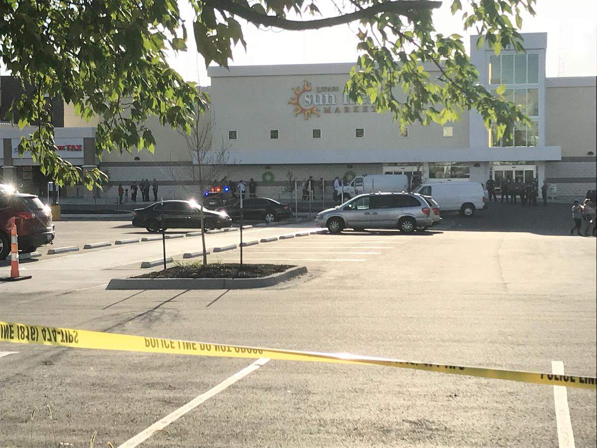 Crime scene tape surrounded the Sun Fresh Market after a shooting on Monday.