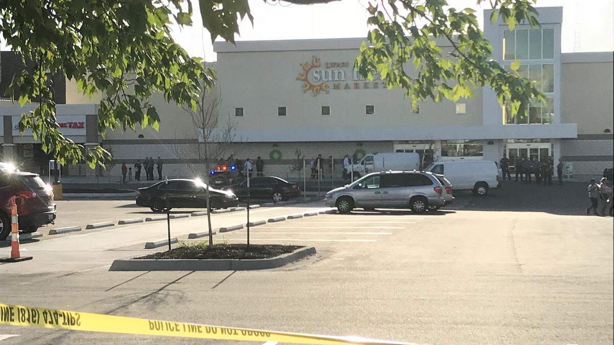 Crime scene tape surrounded the Sun Fresh Market after a shooting on Monday.