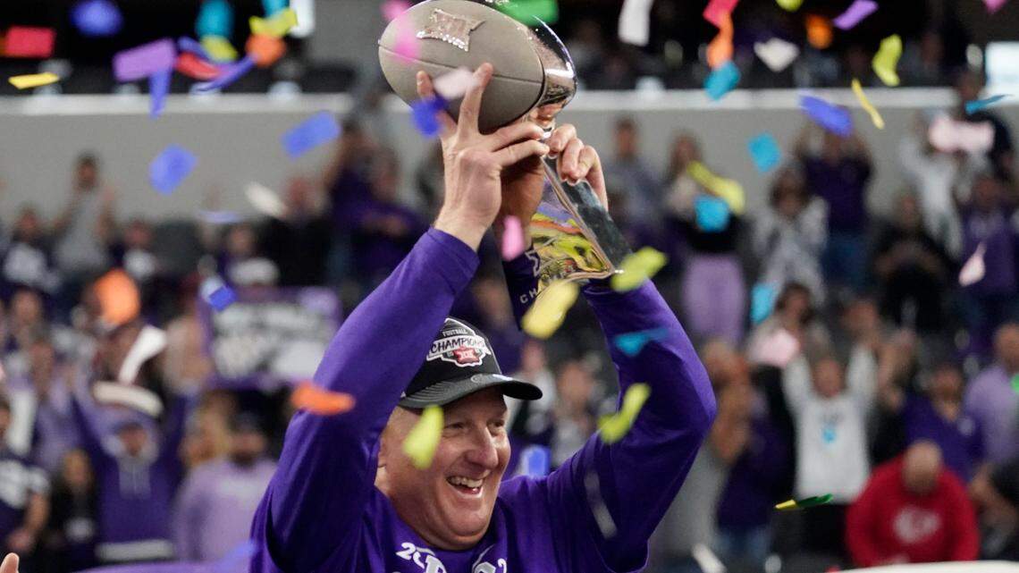 Kansas State coach Chris Klieman holds aloft the Big 12 Championship trophy after his Wildcats defeated TCU in overtime Saturday in Arlington, Texas.