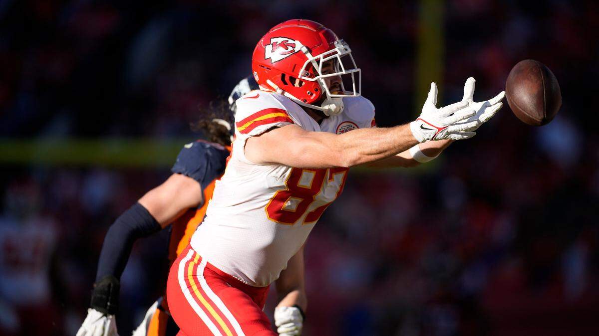Kansas City Chiefs tight end Travis Kelce misses a catch during the first half of an NFL football game against the Denver Broncos Sunday, Dec. 11, 2022, in Denver.