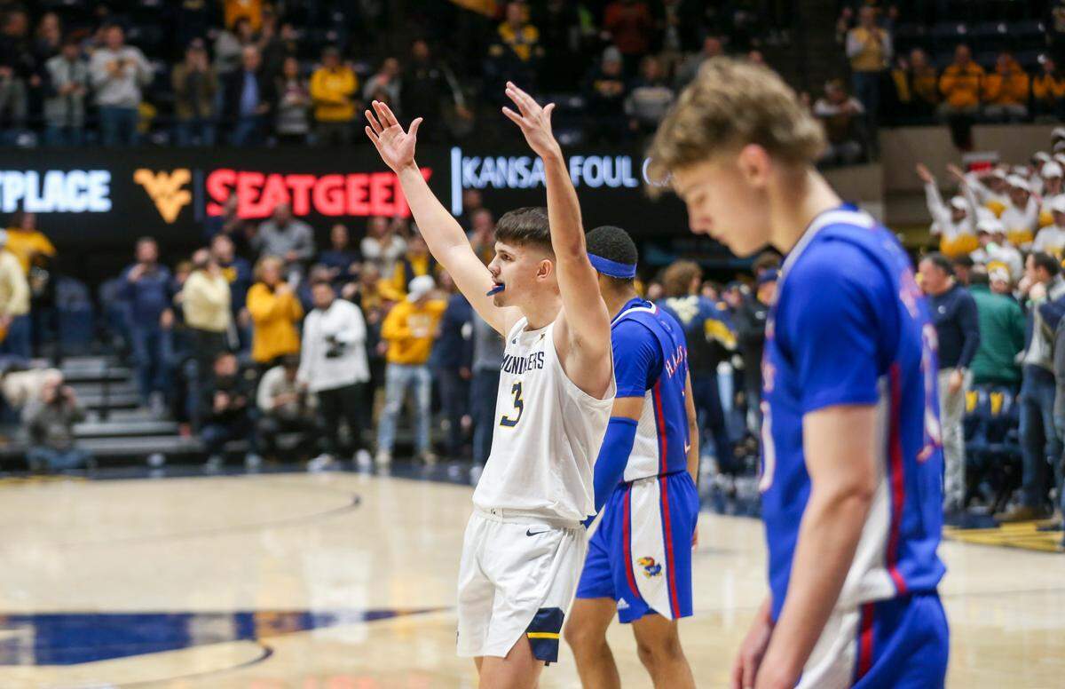 Kerr Kriisa (center) played last season at West Virginia after beginning his college career by playing three seasons at Arizona.