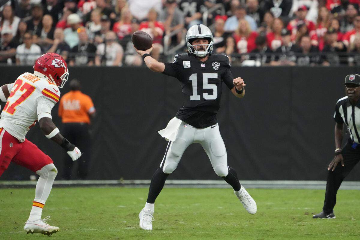 Las Vegas Raiders quarterback Gardner Minshew throws the ball as Kansas City Chiefs safety Chamarri Conner, left, comes into the picture during an Oct. 27, 2024 NFL game at Allegiant Stadium in Paradise, Nevada.