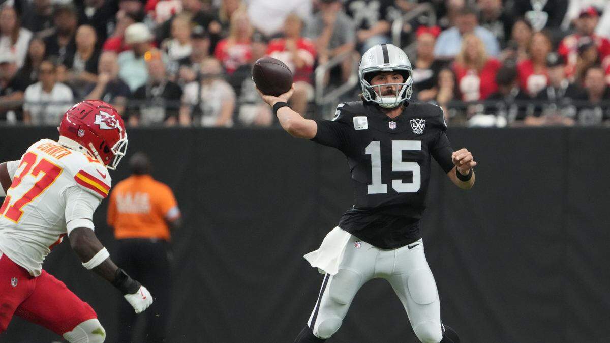 Las Vegas Raiders quarterback Gardner Minshew throws the ball as Kansas City Chiefs safety Chamarri Conner, left, comes into the picture during an Oct. 27, 2024 NFL game at Allegiant Stadium in Paradise, Nevada.