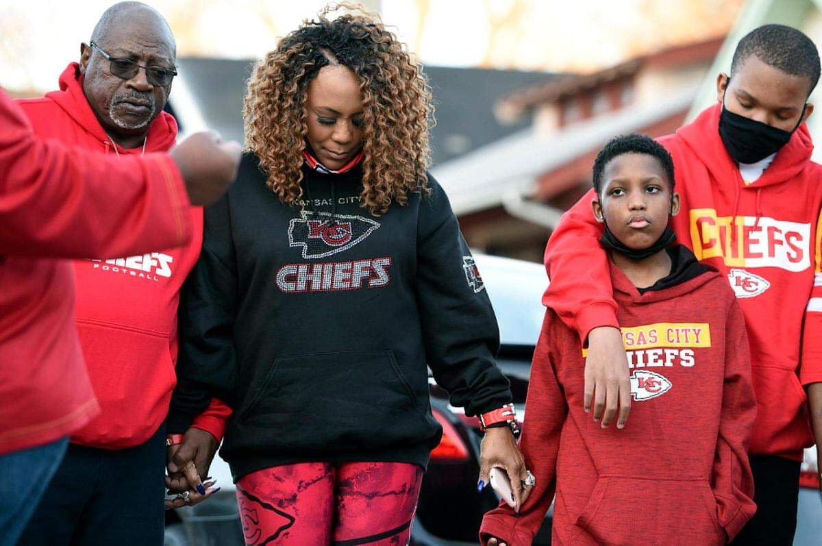 On the second anniversary of his death, the family of Cameron Lamb gathered in front of the house where he was shot and killed in Kansas City. Lamb's stepfather, Aqil Bey, left, and Lamb's mother, Laurie Bey, joined hands in prayer after releasing balloons. 
