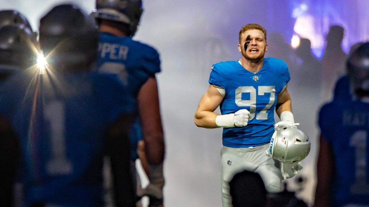 Detroit Lions defensive end Aidan Hutchinson (97) runs onto the field before the start of the game against the Chicago Bears at Ford Field.